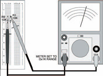 The two parallel resistors shown in the breadboard, with the meter in place to test their combined resistance