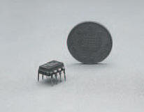 The 555, an 8 pin DIL timer IC, beside a UK one penny piece